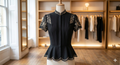 Elegant black blouse with a sleek design and soft fabric.