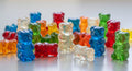 Colorful gummy bears in various shades, including red, blue, green, and orange, featuring a glossy, chewy texture.