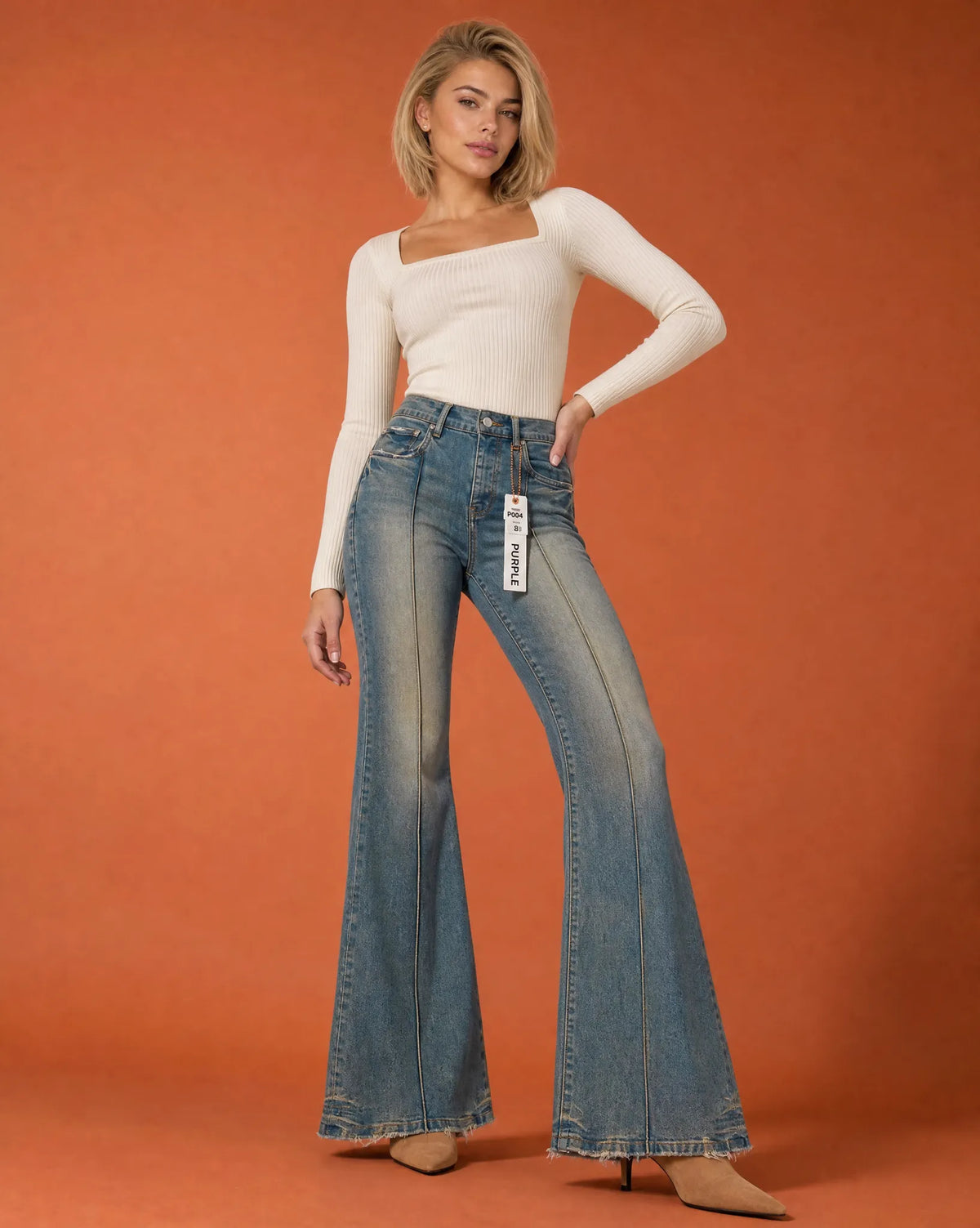Vintage medium wash mid-rise flare jeans in denim, featuring a stylish flared leg and casual fit.