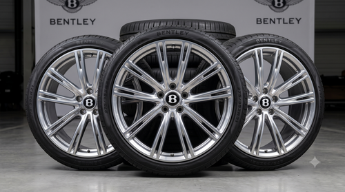 Three polished silver alloy wheels with Bentley insignia and black performance tires displayed in a row.